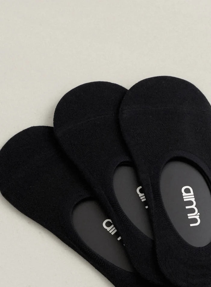 Close-up of three black invisible workout socks with the aim'n logo inside