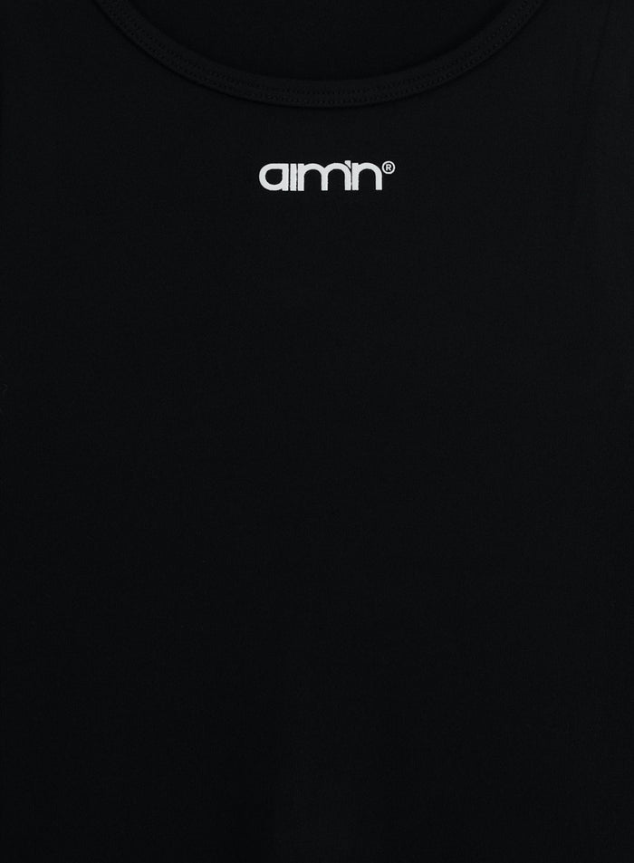 Close-up of black Soft Basic Singlet featuring round neckline and white printed aim'n logo at front.