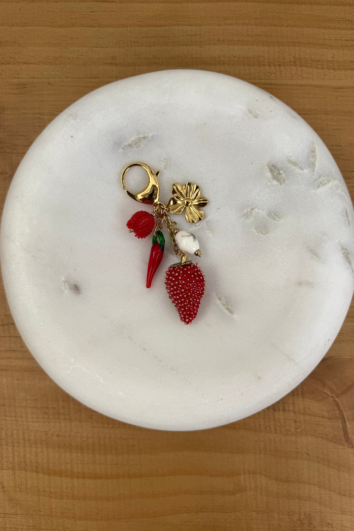keychain with strawberry and other red objects