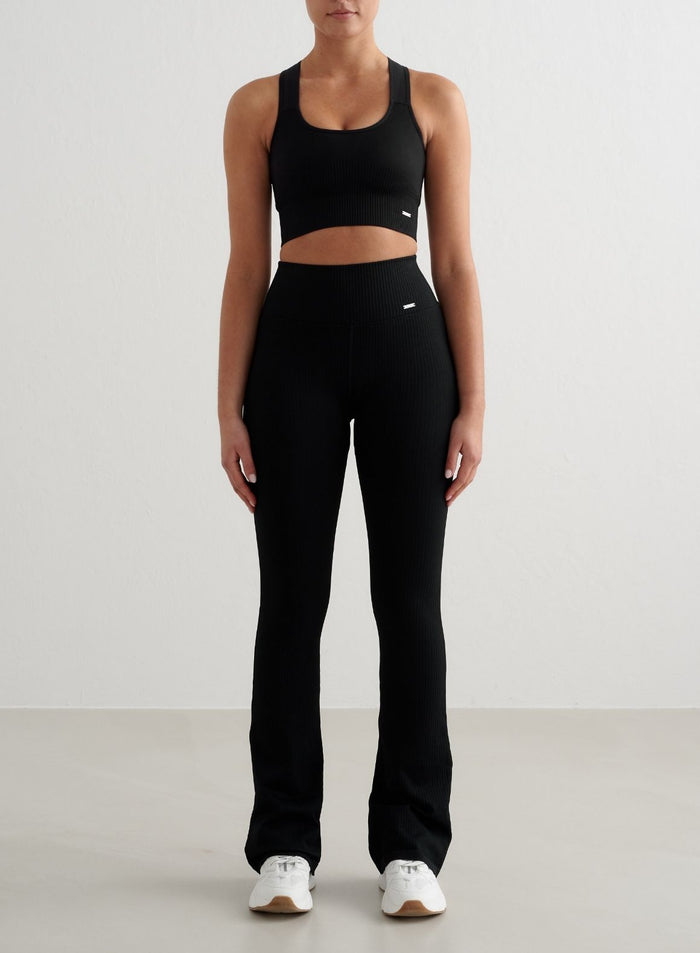 Black ribbed seamless flare tights by aim'n featuring a high waist and flared leg.