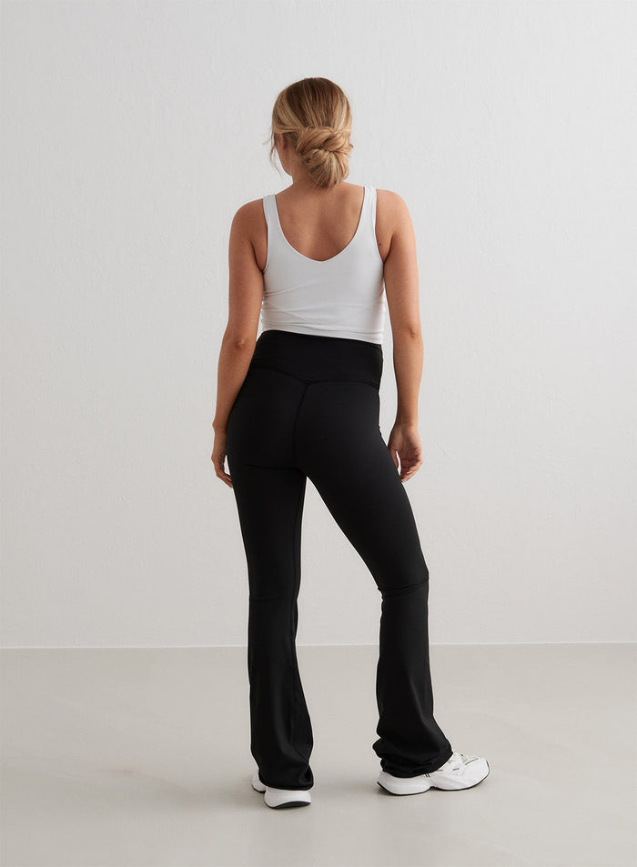 Black aim'n Sense Maternity Flare Tights with a high waistband and flared legs, seen from behind.