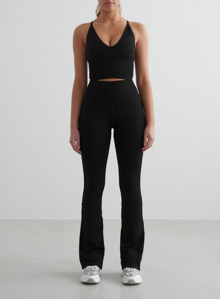Black aim'n Shape Seamless Flare Tights featuring a high, ribbed waist and a flattering flared leg.