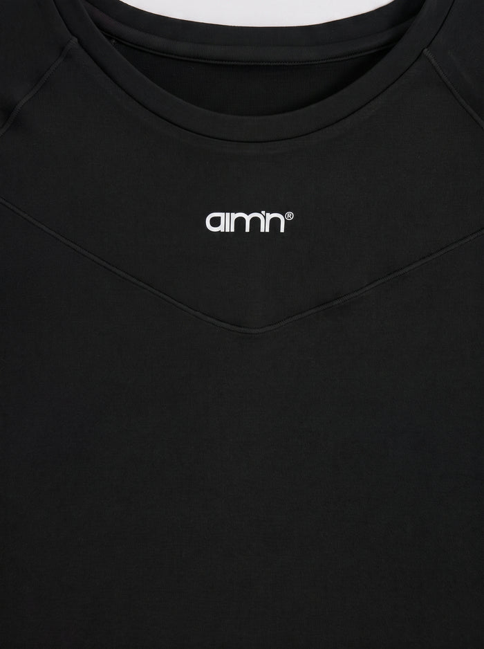 Close-up of the black aim'n Soft Basic Long Sleeve featuring the white logo and second skin feel fabric.