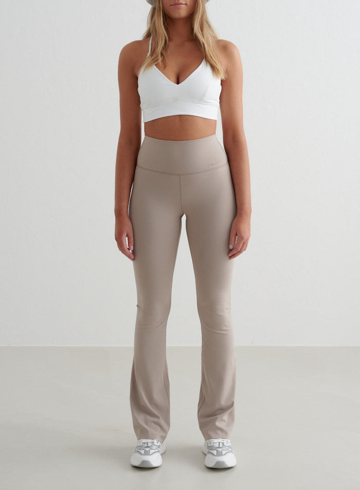 Dark Clay aim'n Sense Flare Tights with a high waist, flared leg and squat proof second skin feel.