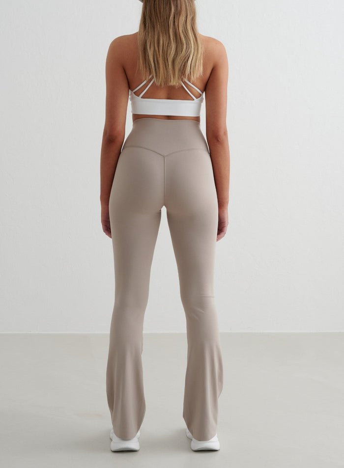 Dark Clay Sense Flare Tights by aim'n featuring a high waist, second skin feel and squat proof flared leg, back view.