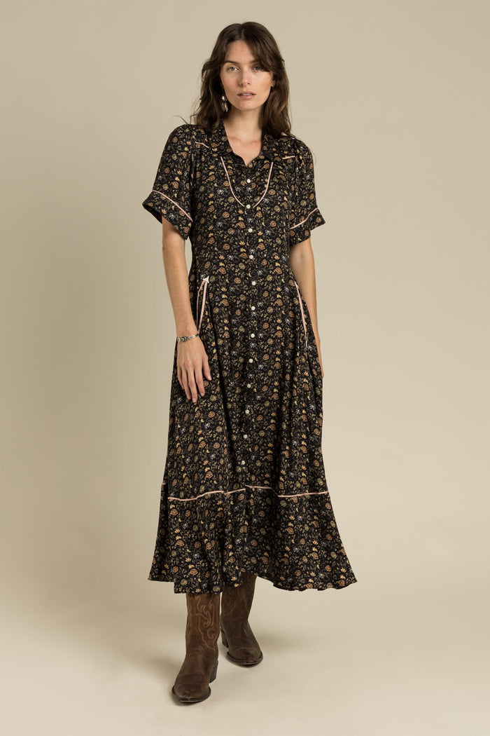 Woman wearing floral midi dress and boots