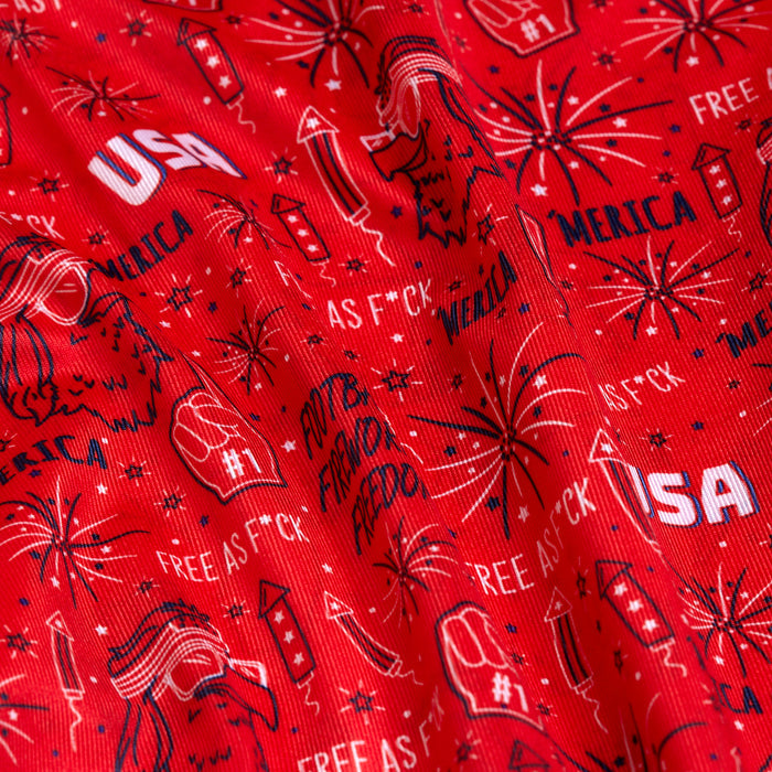 Close-up of the 'Merica - Red - Women's Polo, featuring an athletic fit, moisture-wicking fabric, and bold patriotic designs with fireworks, a bald eagle head, USA text, “’Merica,” #1 foam fingers, and statement phrases in white and navy blue.