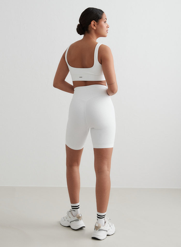 White aim'n Ribbed Seamless Biker Shorts and matching bra set with a second skin fit, shown from behind [S - 176 cm]