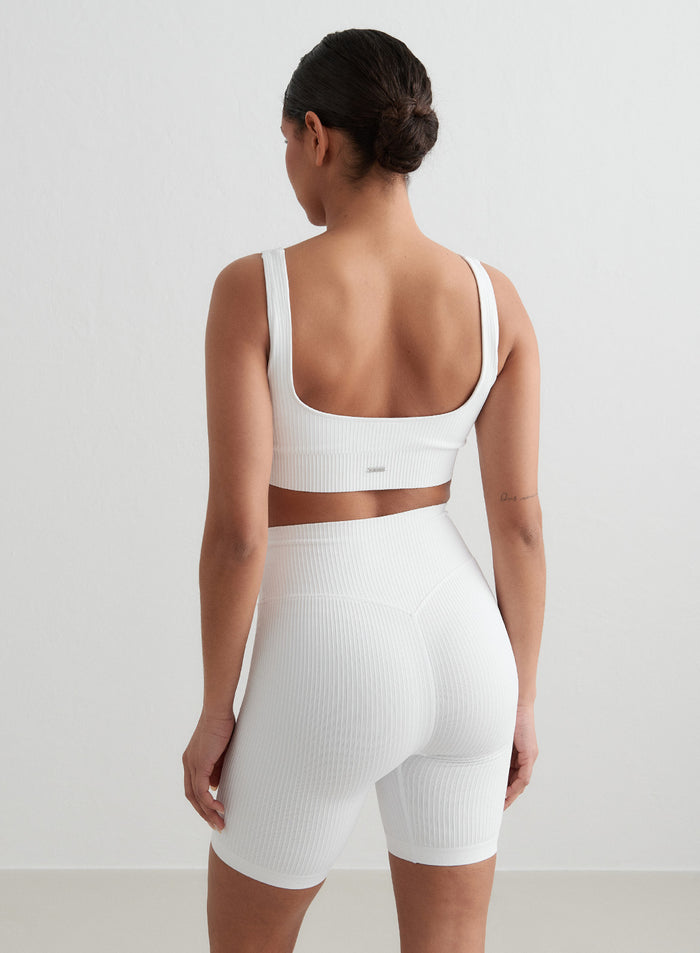 White Ribbed Seamless Biker Shorts and matching sports bra by aim'n, viewed from behind. [S - 176 cm]