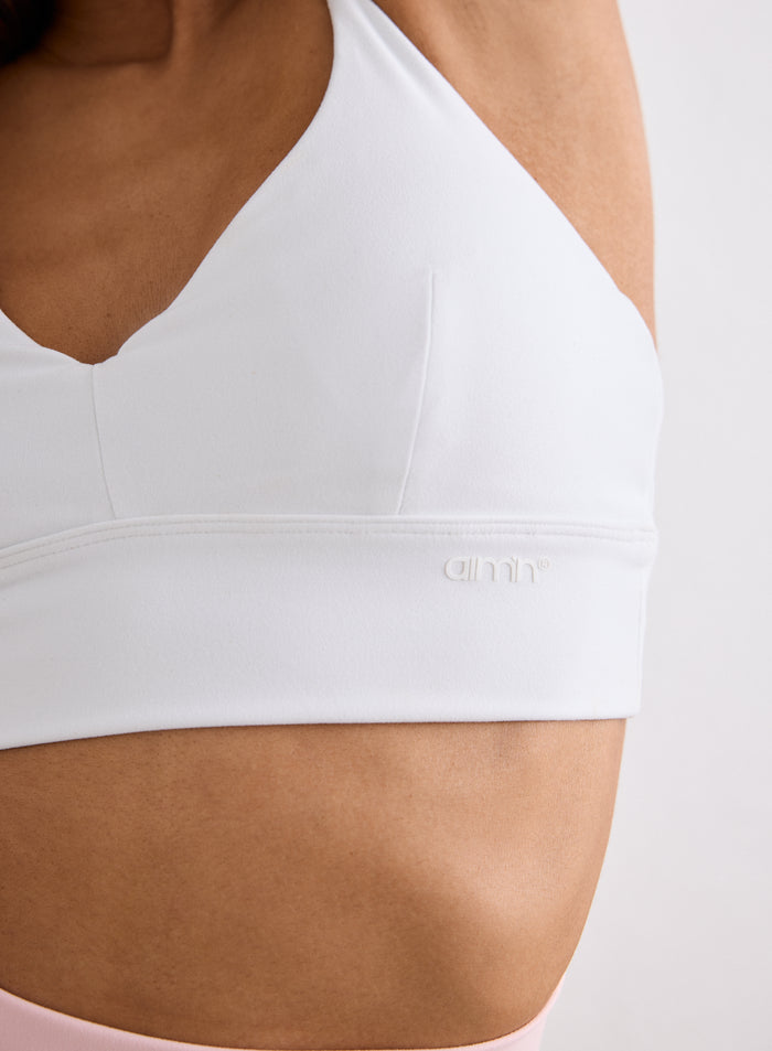 Close-up of the White Sense Strap Bra with a small aim'n logo on the side [XS-170cm]