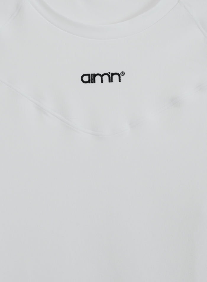 White aim'n Soft Basic Long Sleeve with black logo and second skin fabric shown in a flat lay.